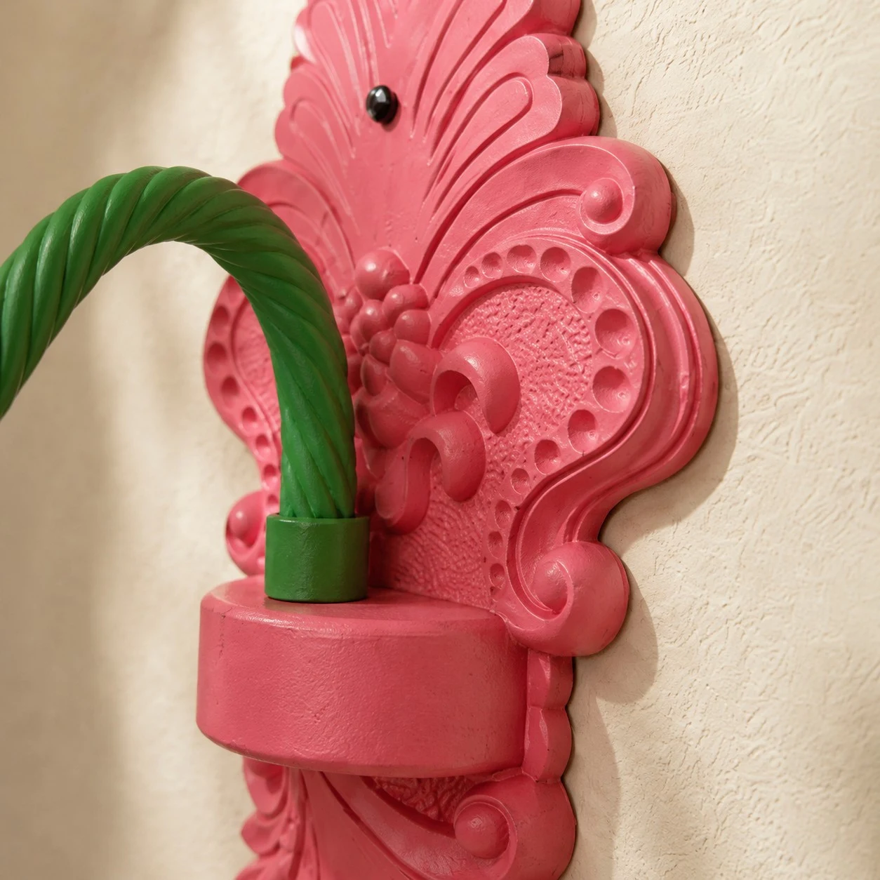 close view of sculpted backplate and curved green arm